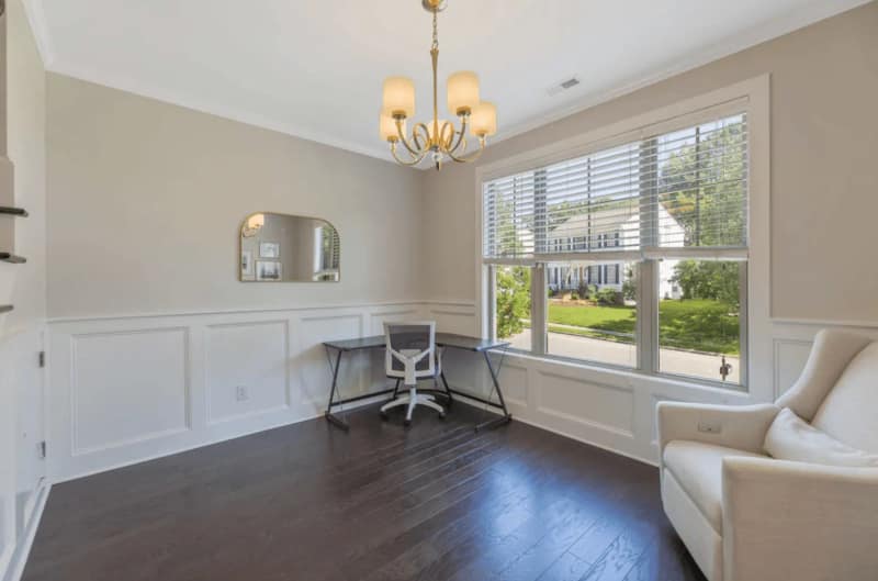 Professionally staged CFR living room with workspace