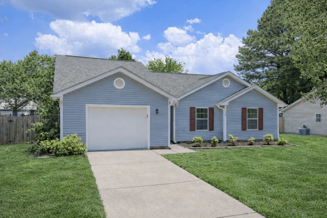 Single-family home with a garage and landscaped front lawn in Southern Wake County