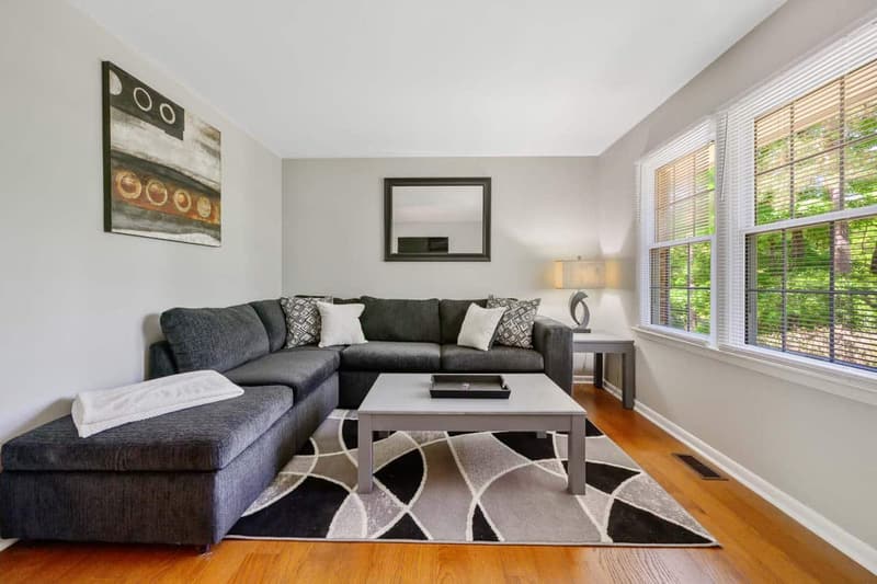 A bright Carolina Furnished Rentals living room with a sectional sofa