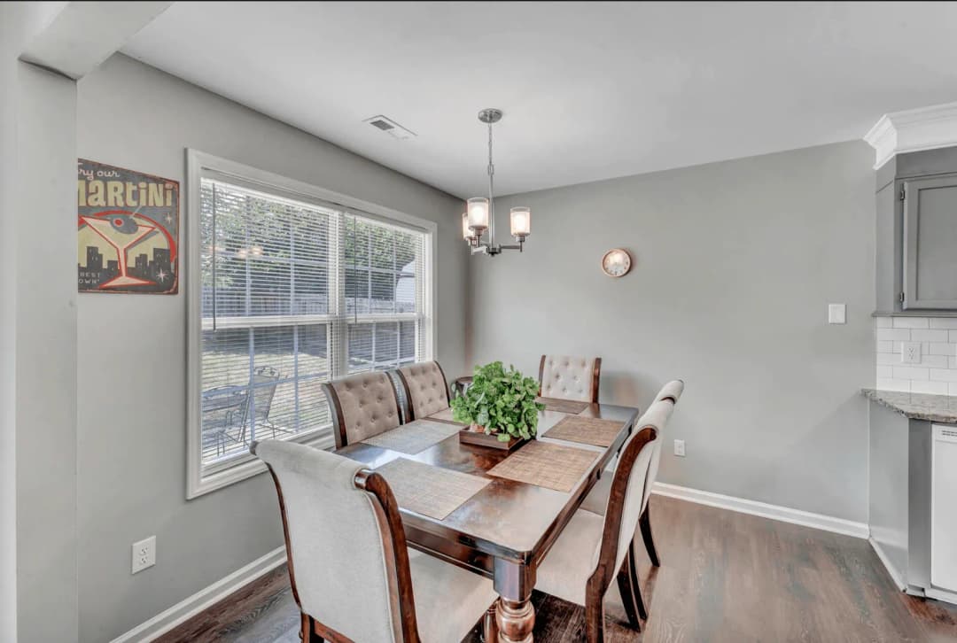 Furnished dining area with a six-seat table and pendant lighting in a CFR home