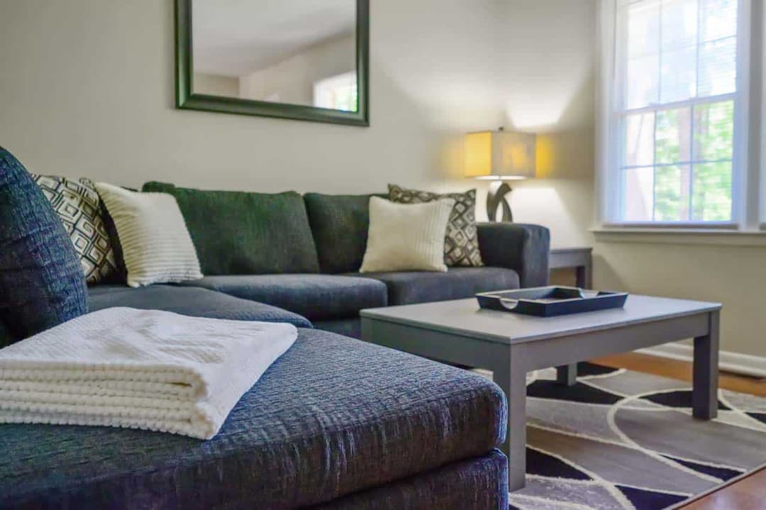 Furnished living room with a sectional sofa in a Carolina Furnished Rentals home
