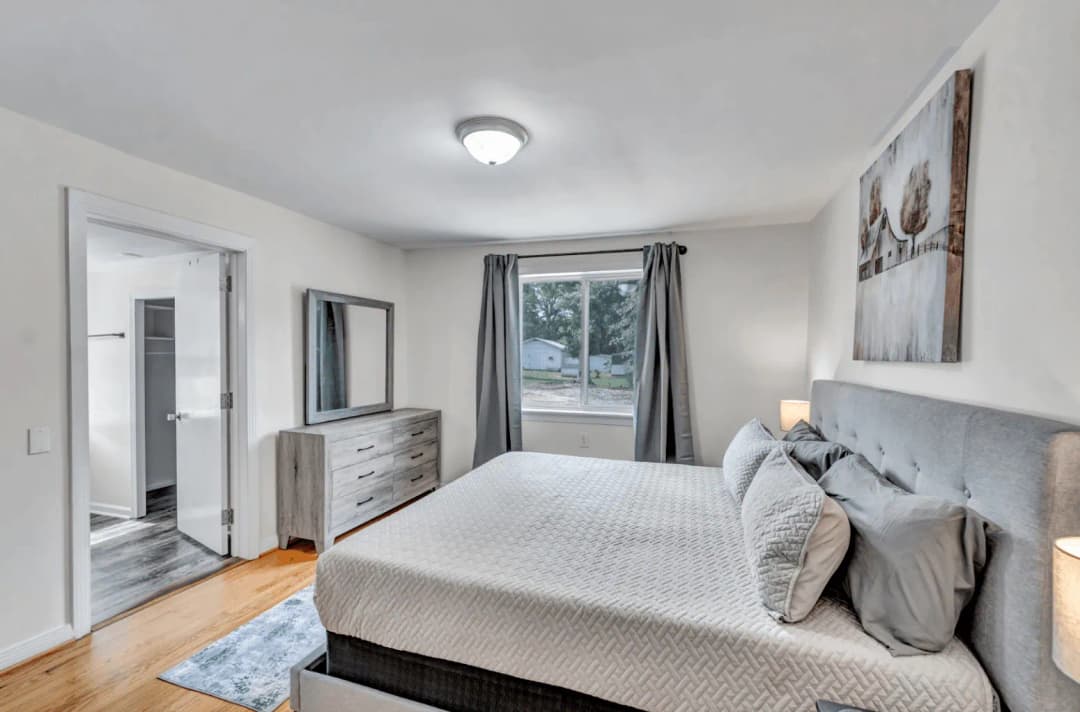 Freshly made bed in a CFR furnished rental bedroom